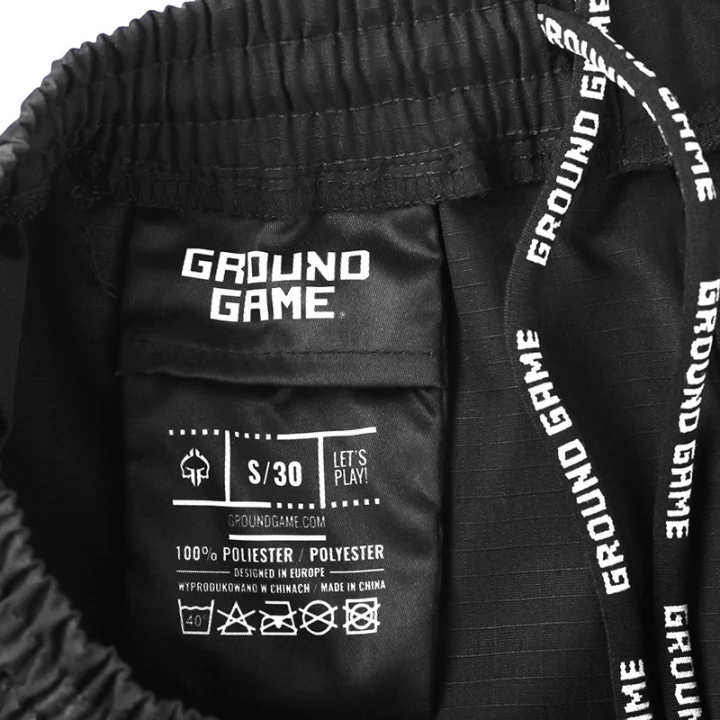 Zbliżenie na wewnętrzną metkę rozmarową i pas spodenek Ground Game Jiu-Jitsu Ripstop